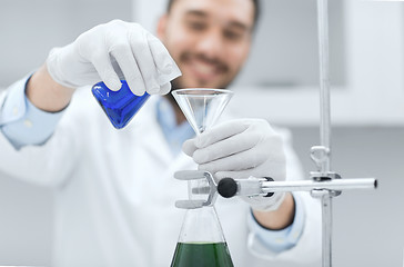 Image showing close up of scientist with test tubes and funnel