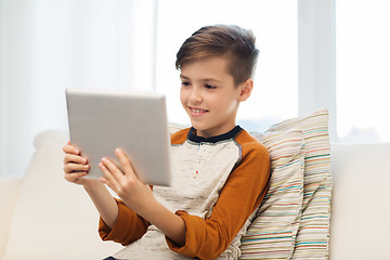 Image showing smiling boy with tablet computer at home