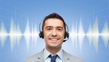 Image showing businessman in headset over sound wave or diagram