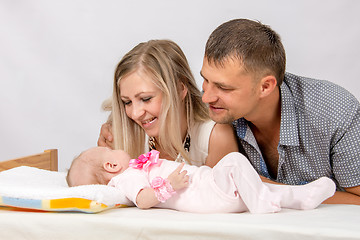 Image showing Happy Mom and Dad look at his two-month baby