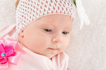 Image showing Portrait of a two-year baby girl with a bandage on his head with a flower