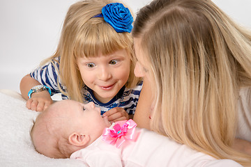 Image showing Five-year girl with amazement looks at his newborn sister