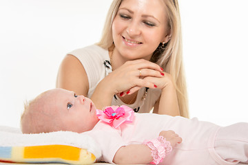 Image showing Mom with a happy smile looking at his baby daughter