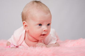 Image showing The two-month girl lying on her stomach her head high