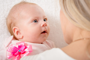 Image showing The two-month baby looking at his mother