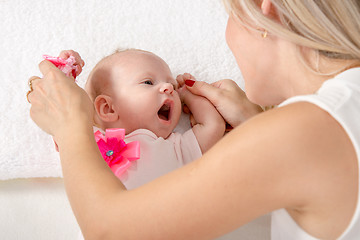 Image showing Mom is looking at a two-month girl with an open mouth