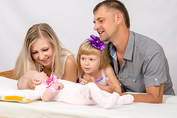 Image showing Mother, father and daughter is considering a five-year new-born baby