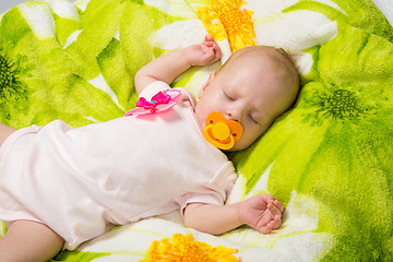 Image showing Sleeping two-month girl sucking a pacifier