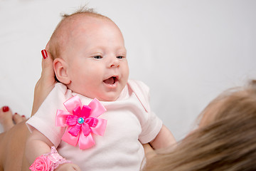 Image showing Mum holds on her lap the two-month baby