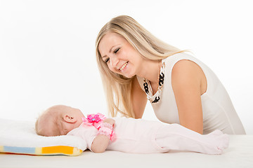 Image showing Happy mother looking at a two-month daughter