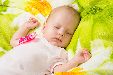 Image showing The two-month baby carefree sleeping on a soft bed