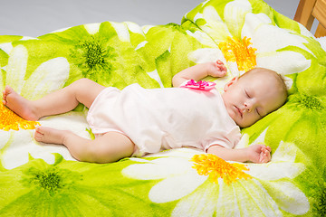 Image showing The two-month baby sleeps happily in bed