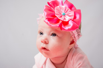 Image showing Portrait of a two-month girl who lies on his stomach head high