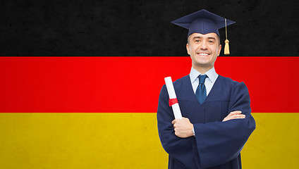 Image showing smiling adult student in mortarboard with diploma