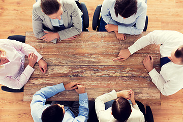 Image showing close up of business team sitting at table