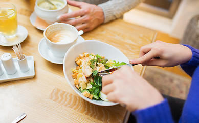 Image showing close up friends having dinner at restaurant