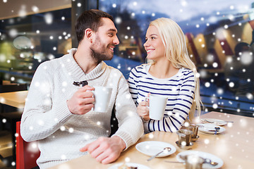 Image showing happy couple meeting and drinking tea or coffee