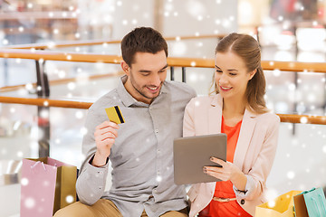 Image showing couple with tablet pc and credit card in mall