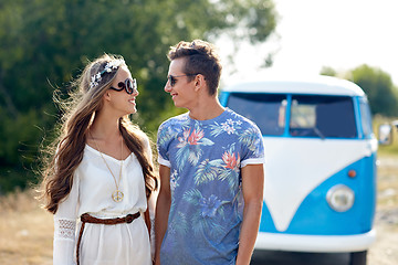 Image showing smiling young hippie couple over minivan car