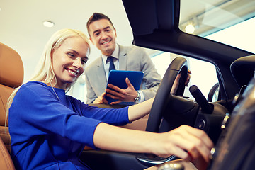 Image showing happy woman with car dealer in auto show or salon