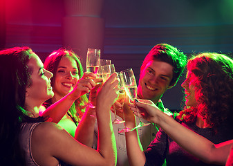 Image showing smiling friends with glasses of champagne in club