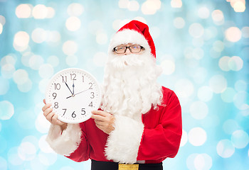 Image showing man in costume of santa claus with clock