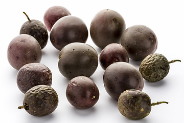 Image showing Fourteen Whole Purple Passion Fruits On White 