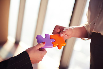 Image showing business people group assembling jigsaw puzzle