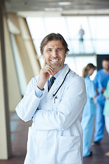 Image showing group of medical staff at hospital, handsome doctor in front of 