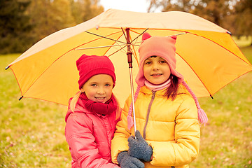 Image showing happy little girls with umbrella in autumn park