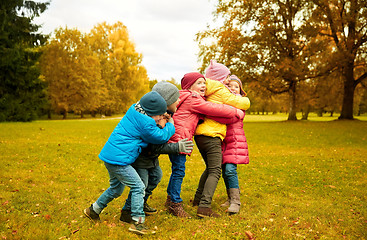 Image showing group of happy children hugging in autumn park