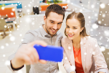 Image showing happy couple taking selfie with smartphone in cafe