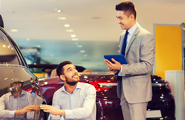 Image showing happy man with car dealer in auto show or salon