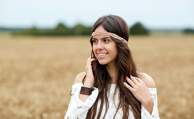 Image showing smiling young hippie woman on cereal field