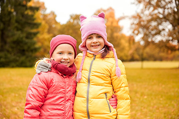 Image showing two happy little girls hugging in autumn park