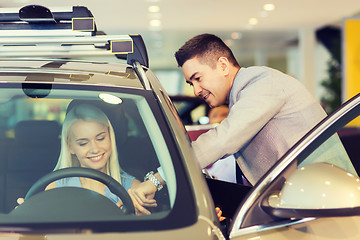 Image showing happy woman with car dealer in auto show or salon