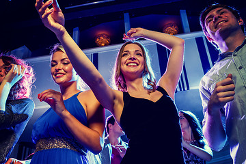 Image showing smiling friends dancing in club