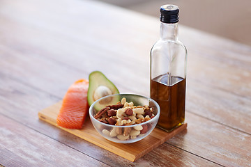 Image showing close up of food and olive oil bottle on table