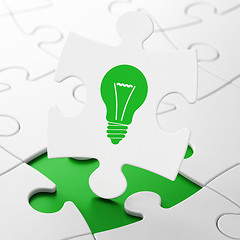 Image showing Finance concept: Light Bulb on puzzle background