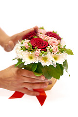 Image showing Human hands standing a pot with flowers