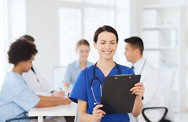 Image showing happy doctor over group of medics at hospital