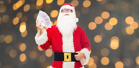 Image showing man in costume of santa claus with euro money