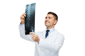 Image showing smiling male doctor in white coat looking at x-ray