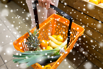 Image showing close up of woman with food basket in market