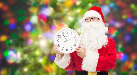 Image showing man in costume of santa claus with clock