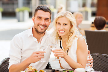 Image showing happy couple clinking glasses at restaurant lounge