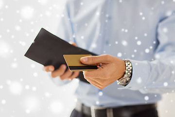 Image showing close up of man holding wallet and credit card