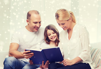 Image showing happy family with book at home