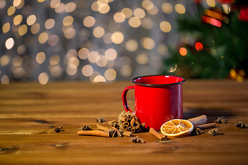 Image showing tea cup with winter spices on wooden table