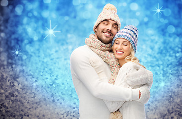 Image showing smiling couple in winter clothes hugging